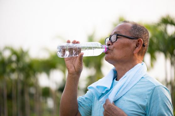 Older man drinking water