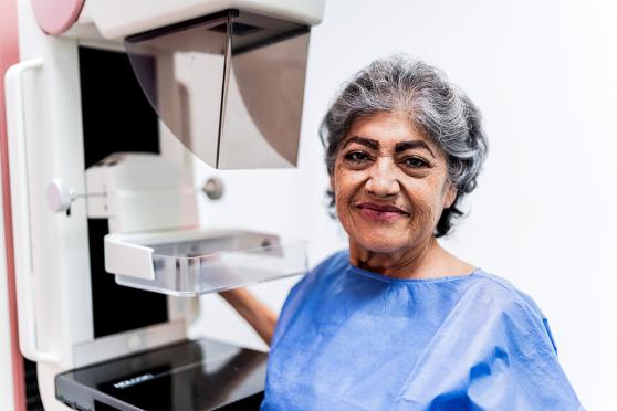 Smiling senior woman getting a mammogram