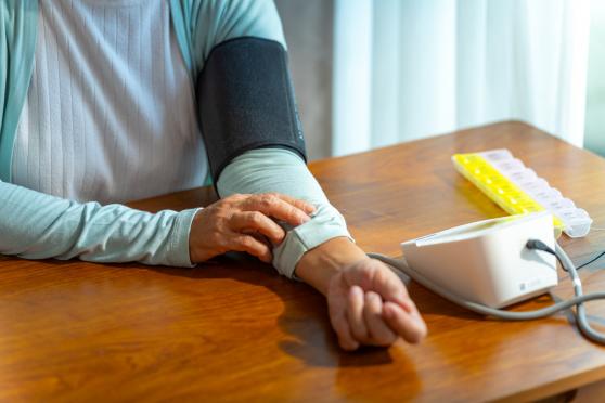 Older woman taking blood pressure at home